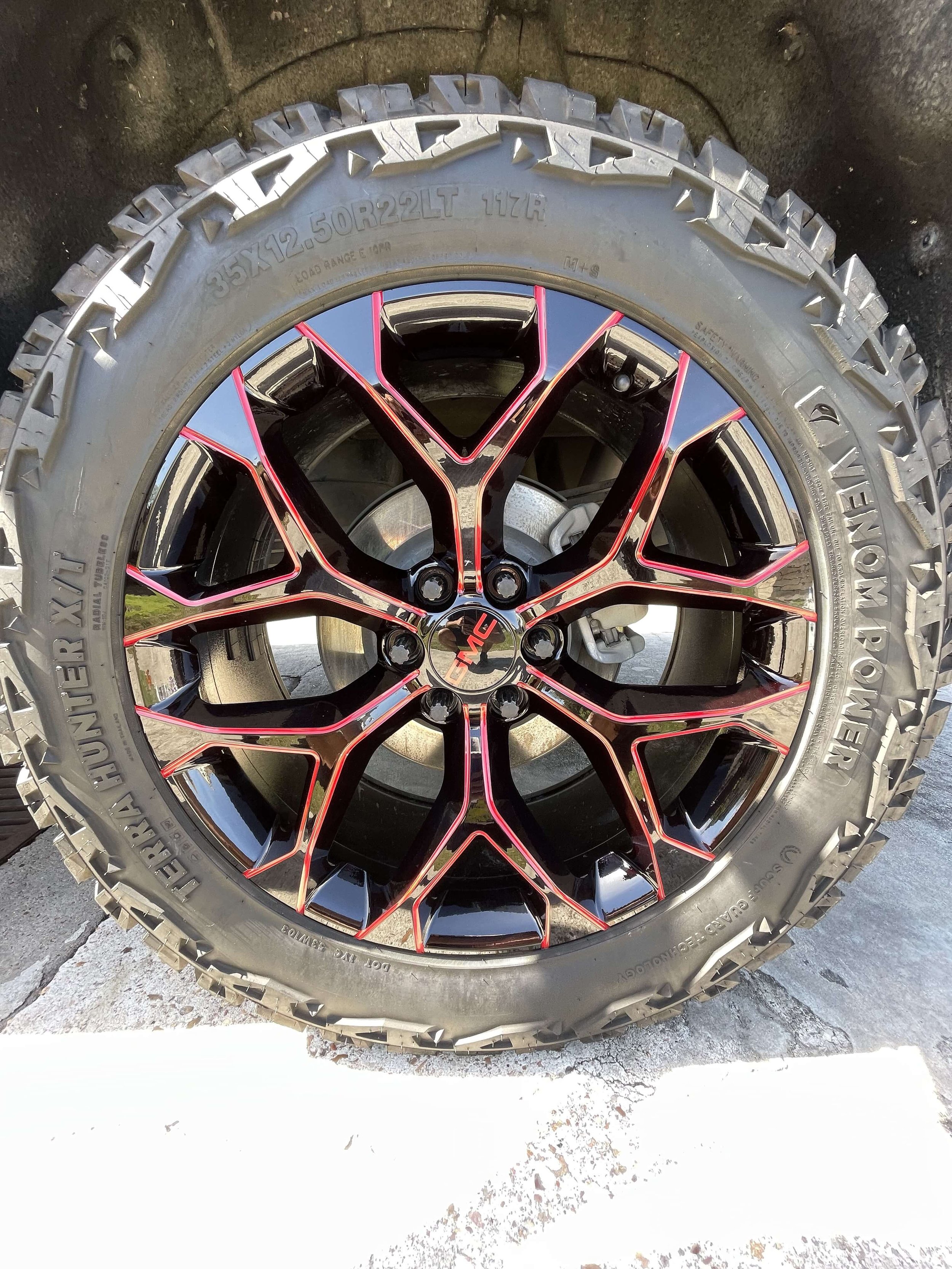 Detailed GMC wheel and tire with clean red-accented rim